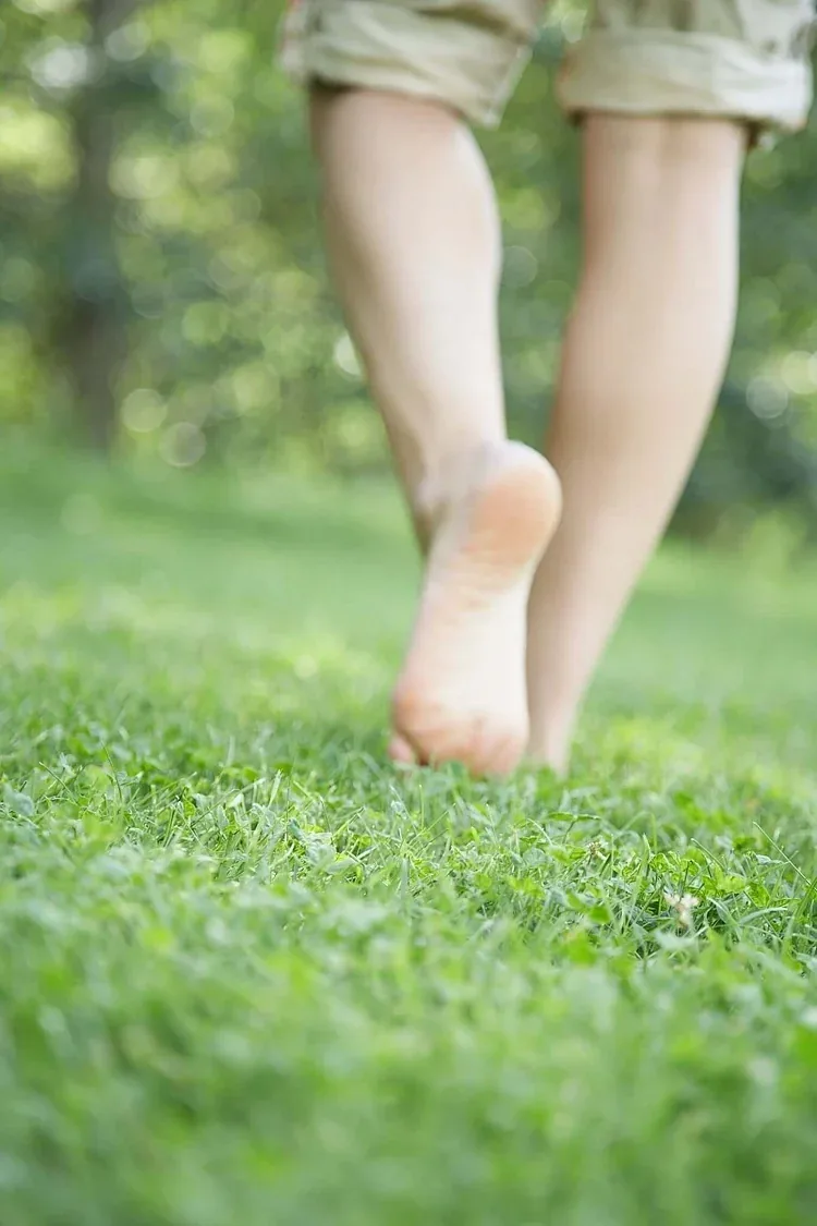 Bare feet walking on grass, the natural form of grounding